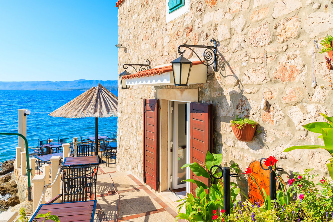 Idyllic coastal restaurant in Bol, Croatia. Taste local cuisine, admire Adriatic beauty by sandy shores.