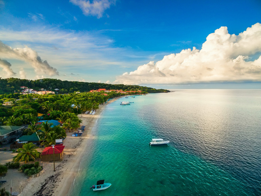Aerial view of a tranquil tropical beach in Roatán, Honduras at dawn