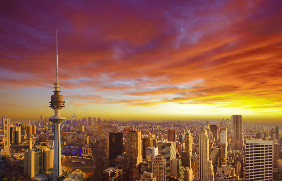 Urban skyline of Kuwait City at dusk.