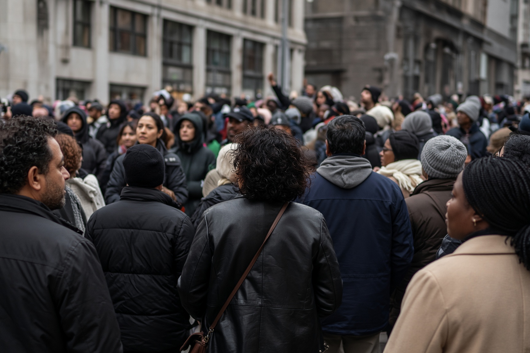 Crowd gathered in a city street illustrating the subject of A World in Protest